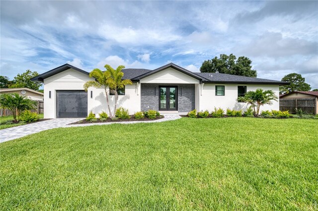 view of front of property featuring a front lawn and a garage