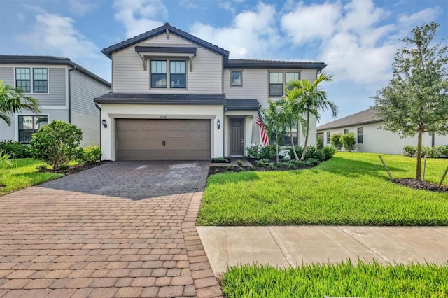 view of front of house with a front yard and a garage