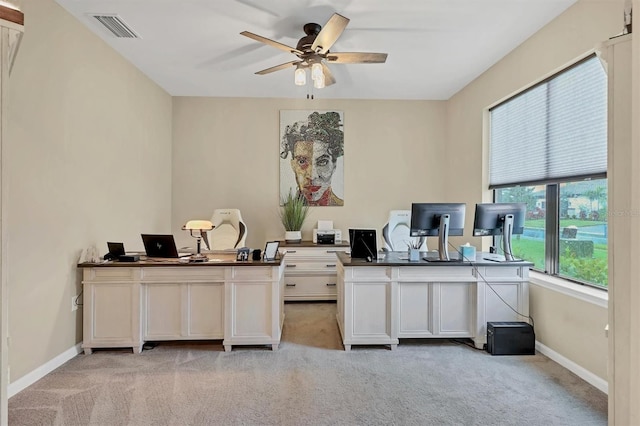 office space featuring ceiling fan and light carpet