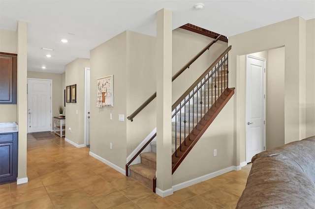 stairs with light tile patterned floors