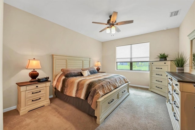 bedroom with light colored carpet and ceiling fan