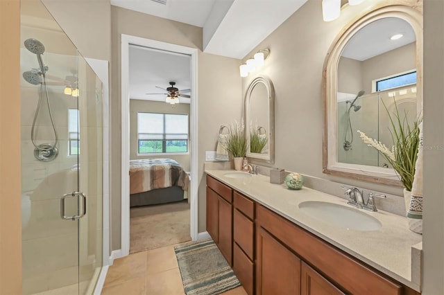 bathroom with ceiling fan, tile patterned flooring, double sink vanity, and walk in shower