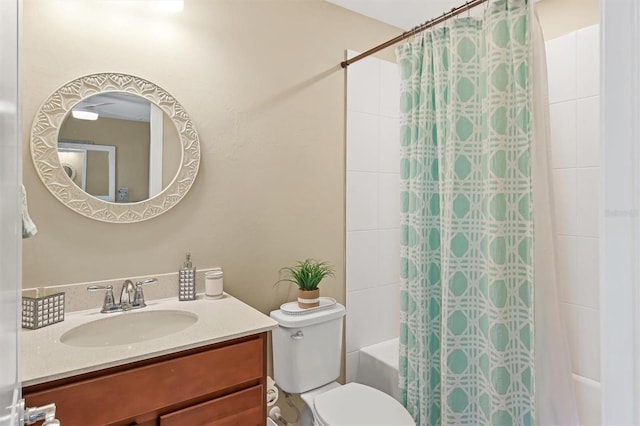 full bathroom featuring toilet, shower / bath combo with shower curtain, and vanity