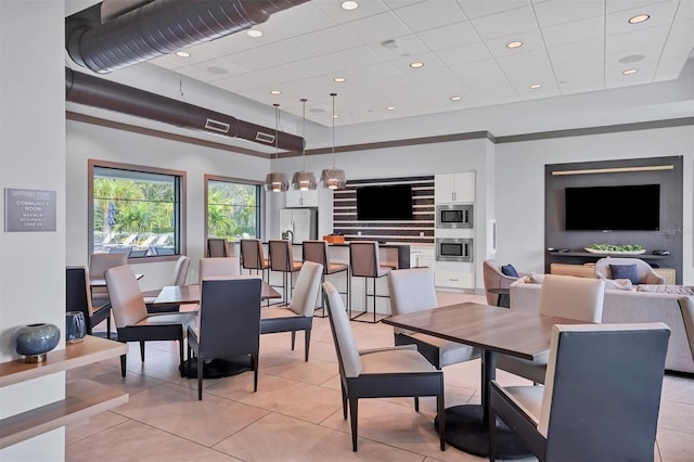 tiled dining room with a towering ceiling