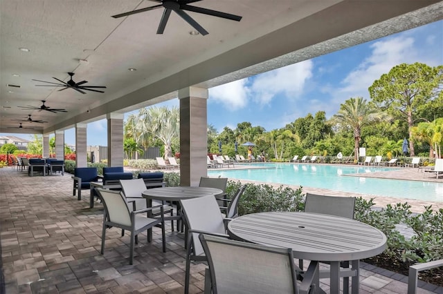 view of patio with ceiling fan and a community pool