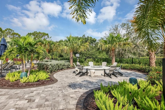 view of property's community featuring a patio and a fire pit