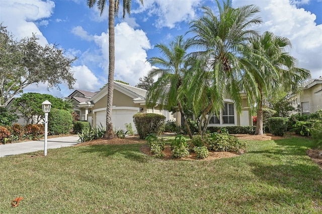 view of front of property with a garage and a front lawn