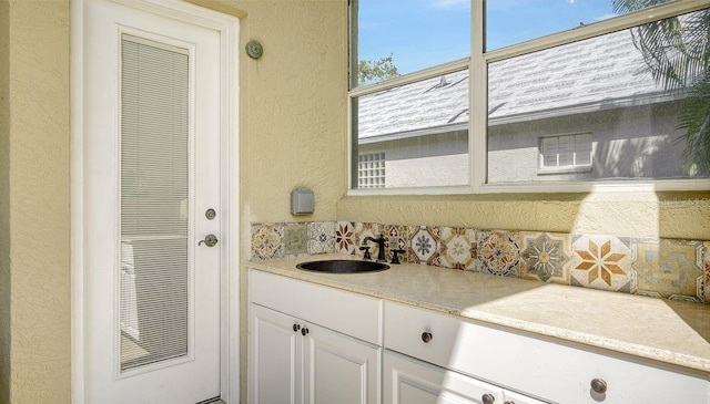 bathroom featuring vanity and backsplash