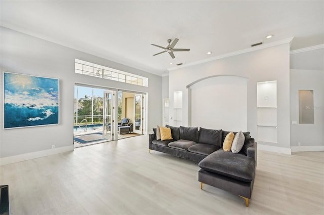 living room featuring crown molding, light hardwood / wood-style flooring, and ceiling fan