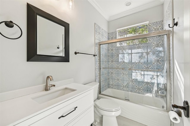 full bathroom featuring ornamental molding, vanity, bath / shower combo with glass door, and toilet