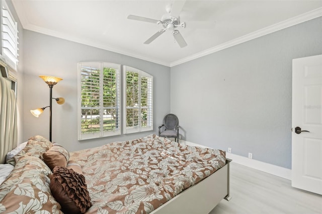 bedroom featuring ornamental molding, ceiling fan, and light wood-type flooring