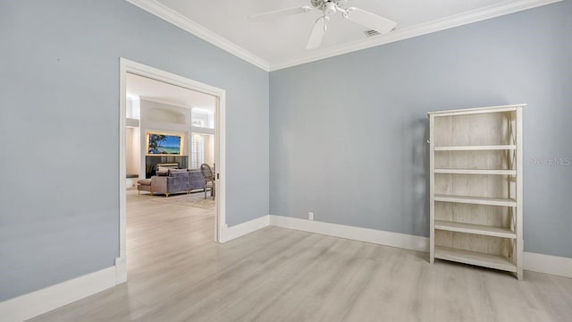 empty room featuring crown molding, ceiling fan, and light wood-type flooring