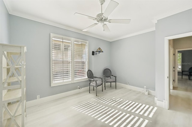 sitting room with crown molding and ceiling fan