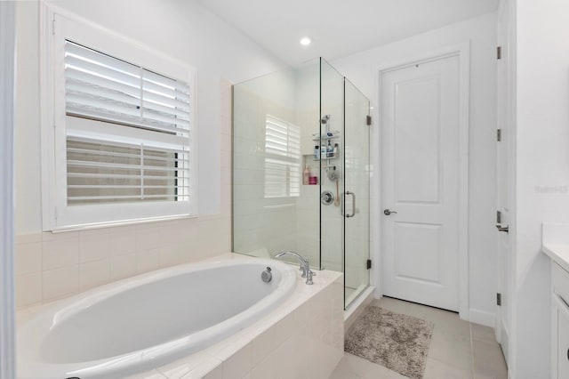 bathroom featuring vanity, separate shower and tub, and tile patterned flooring