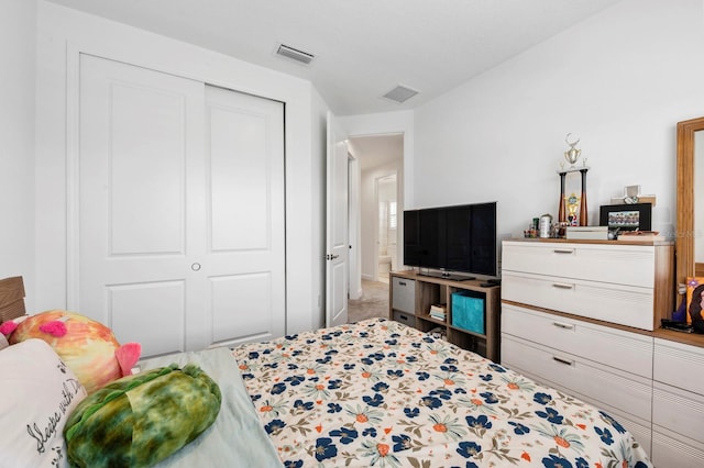 carpeted bedroom with a closet