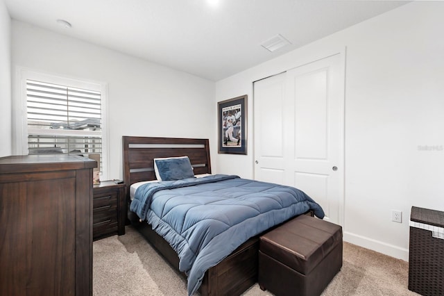 carpeted bedroom with a closet