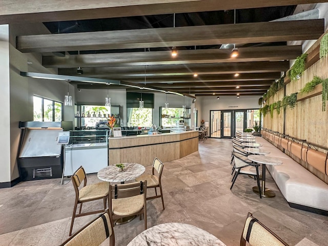 interior space featuring beam ceiling, light tile patterned flooring, and french doors