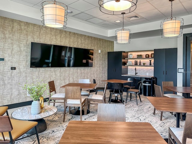 dining room featuring a paneled ceiling and sink