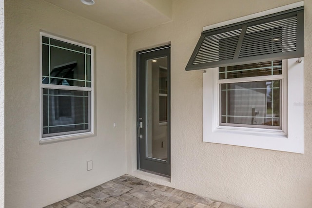 view of exterior entry featuring a patio area