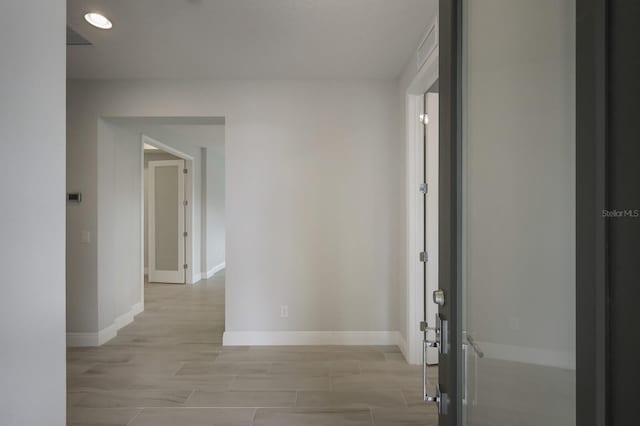 corridor with light wood-type flooring