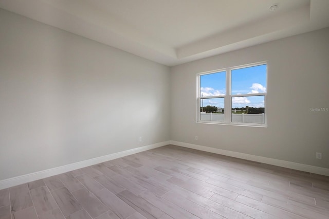 spare room with light hardwood / wood-style flooring