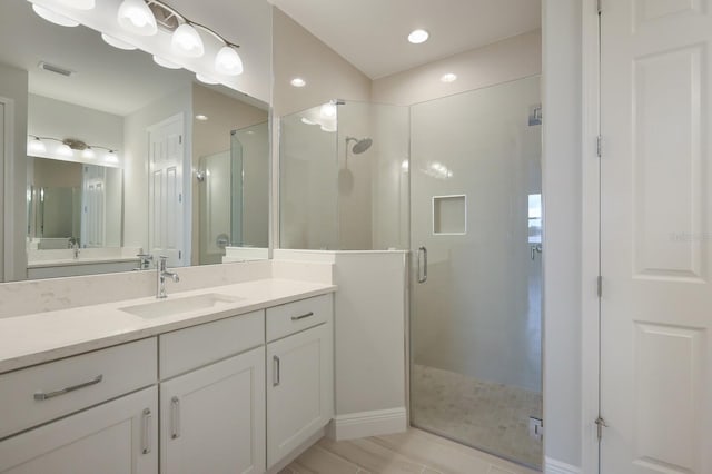 bathroom featuring vanity and walk in shower