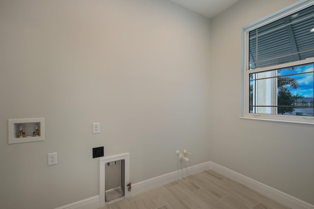 laundry room with hookup for a gas dryer, electric dryer hookup, washer hookup, and light wood-type flooring