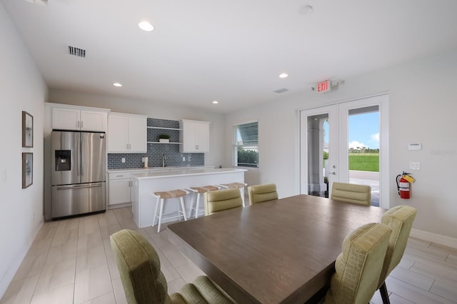 dining space featuring sink and french doors