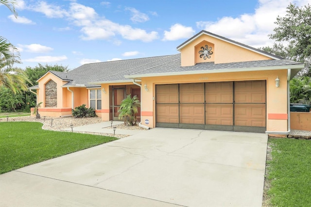 single story home featuring a garage and a front yard