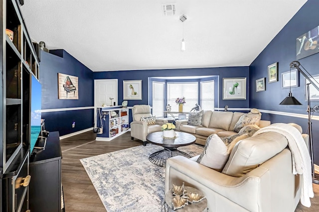 living room featuring vaulted ceiling and dark wood-type flooring