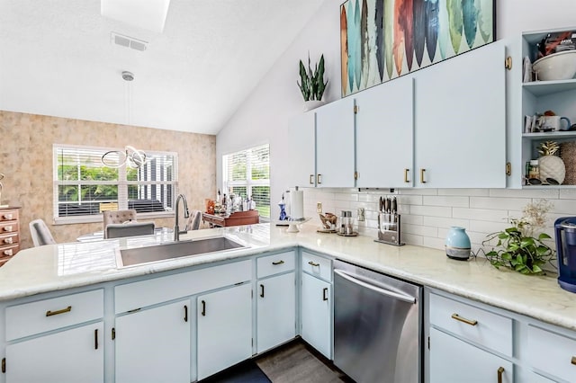 kitchen featuring a wealth of natural light, dishwasher, lofted ceiling, and sink