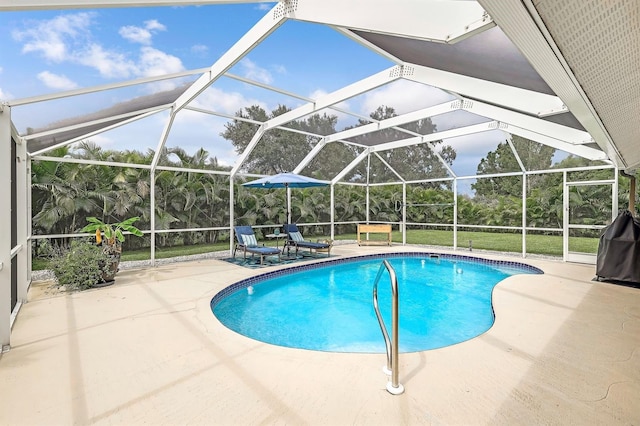 view of pool with a lawn, a lanai, and a patio