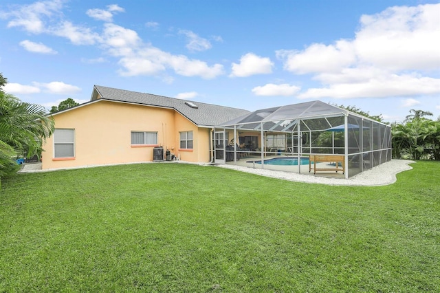 back of house featuring glass enclosure, central AC, and a lawn