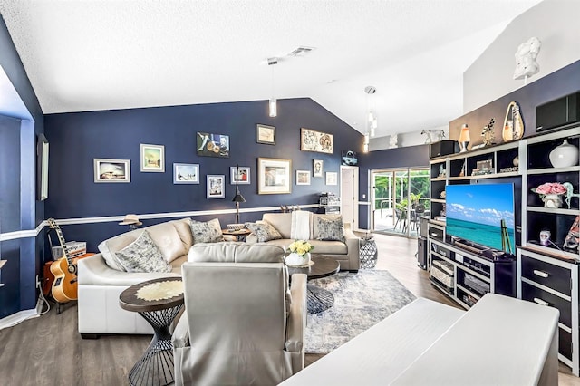 living room with vaulted ceiling and wood-type flooring