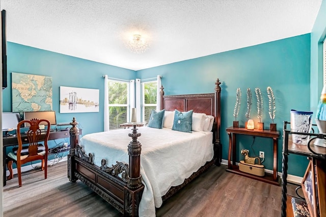 bedroom featuring a textured ceiling and wood-type flooring