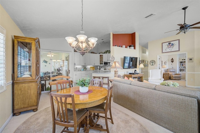 carpeted dining area featuring vaulted ceiling, a wealth of natural light, ceiling fan with notable chandelier, and sink