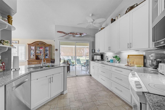 kitchen with appliances with stainless steel finishes, backsplash, plenty of natural light, and white cabinetry