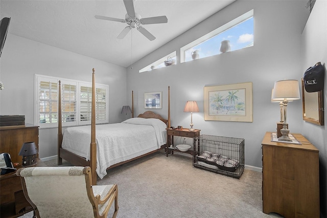 carpeted bedroom featuring ceiling fan and high vaulted ceiling