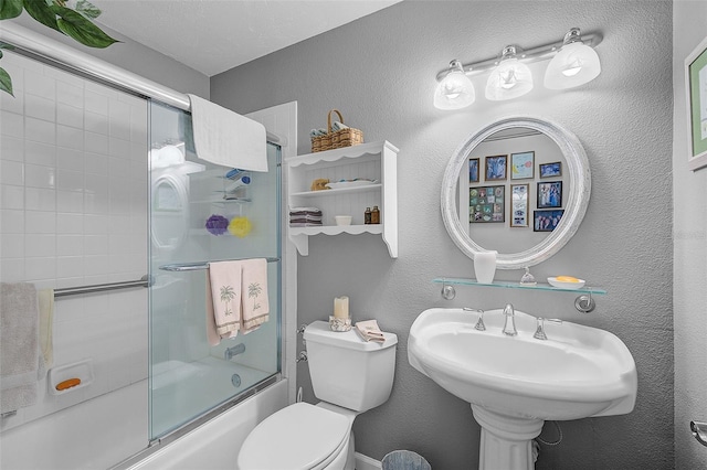 bathroom featuring enclosed tub / shower combo and toilet