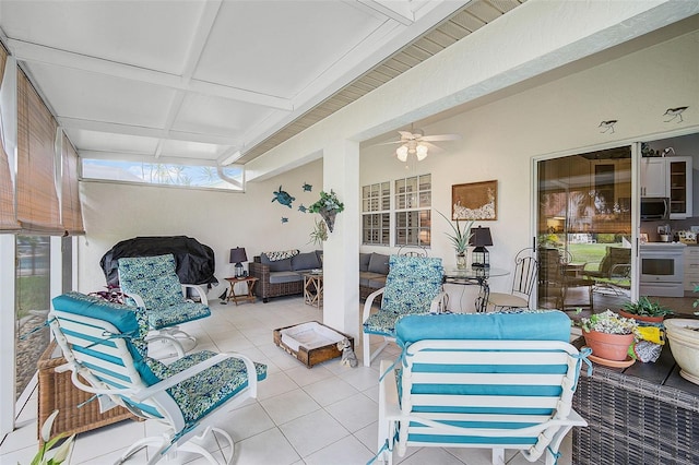 sunroom / solarium with ceiling fan and coffered ceiling