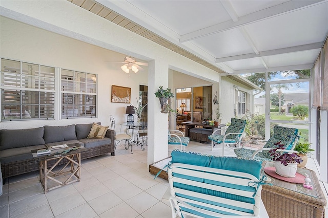 sunroom / solarium with beam ceiling and ceiling fan