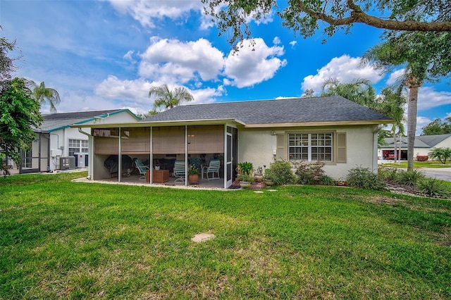 rear view of house with a yard