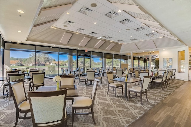 dining room with expansive windows, plenty of natural light, and hardwood / wood-style flooring