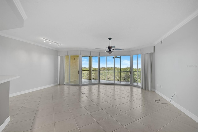 empty room with crown molding, ceiling fan, track lighting, and light tile patterned floors