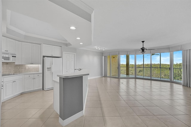 kitchen with crown molding, white appliances, decorative backsplash, and white cabinets