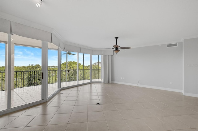 unfurnished room with light tile patterned floors, crown molding, and ceiling fan