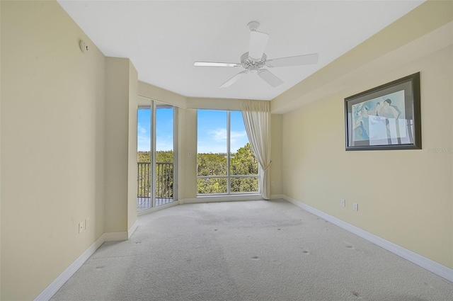 empty room featuring light carpet and ceiling fan