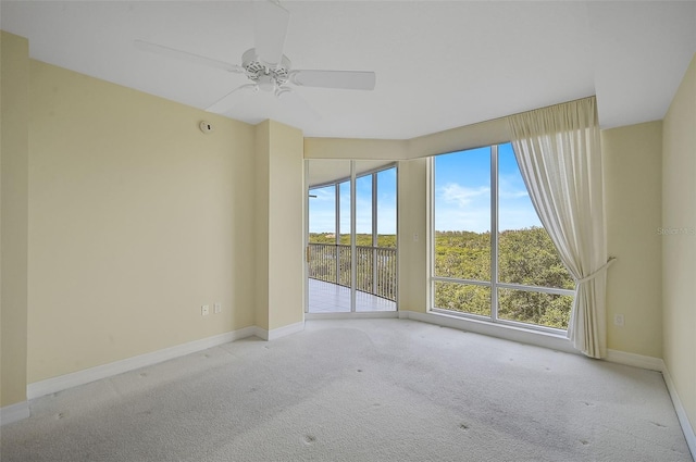 spare room featuring ceiling fan and light carpet