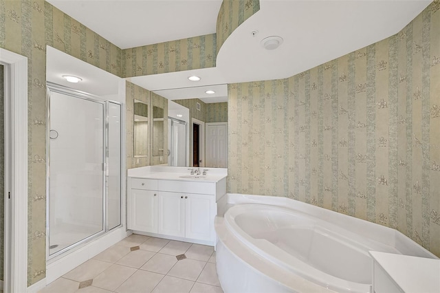 bathroom with tile patterned flooring, vanity, and shower with separate bathtub