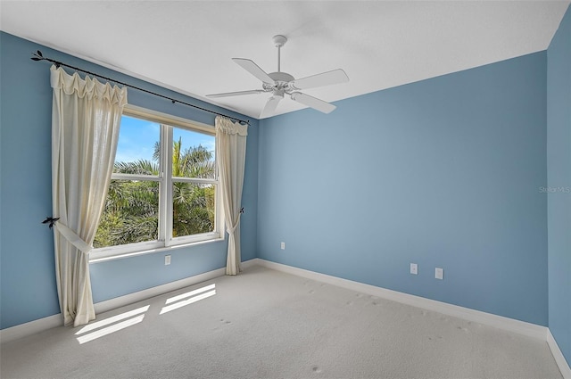 spare room with ceiling fan and carpet flooring